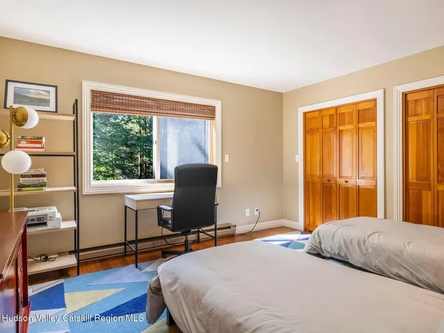 a bed room with a bed and a chair