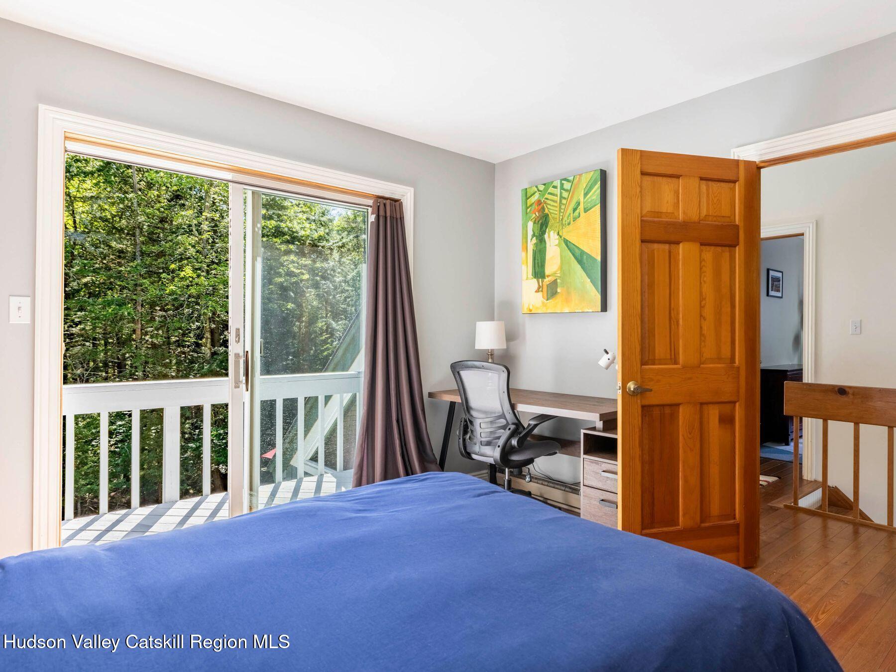 36 Mt Greenery Road Windham, NY 12496 - Photo 29 of 60 a bedroom with a bed and a table next to a window