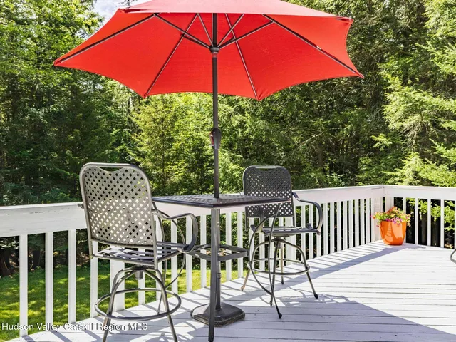 a view of a chairs and table on the wooden deck