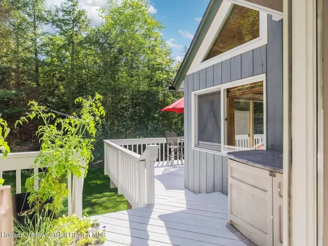 a view of a balcony with table and chairs and floor to ceiling window
