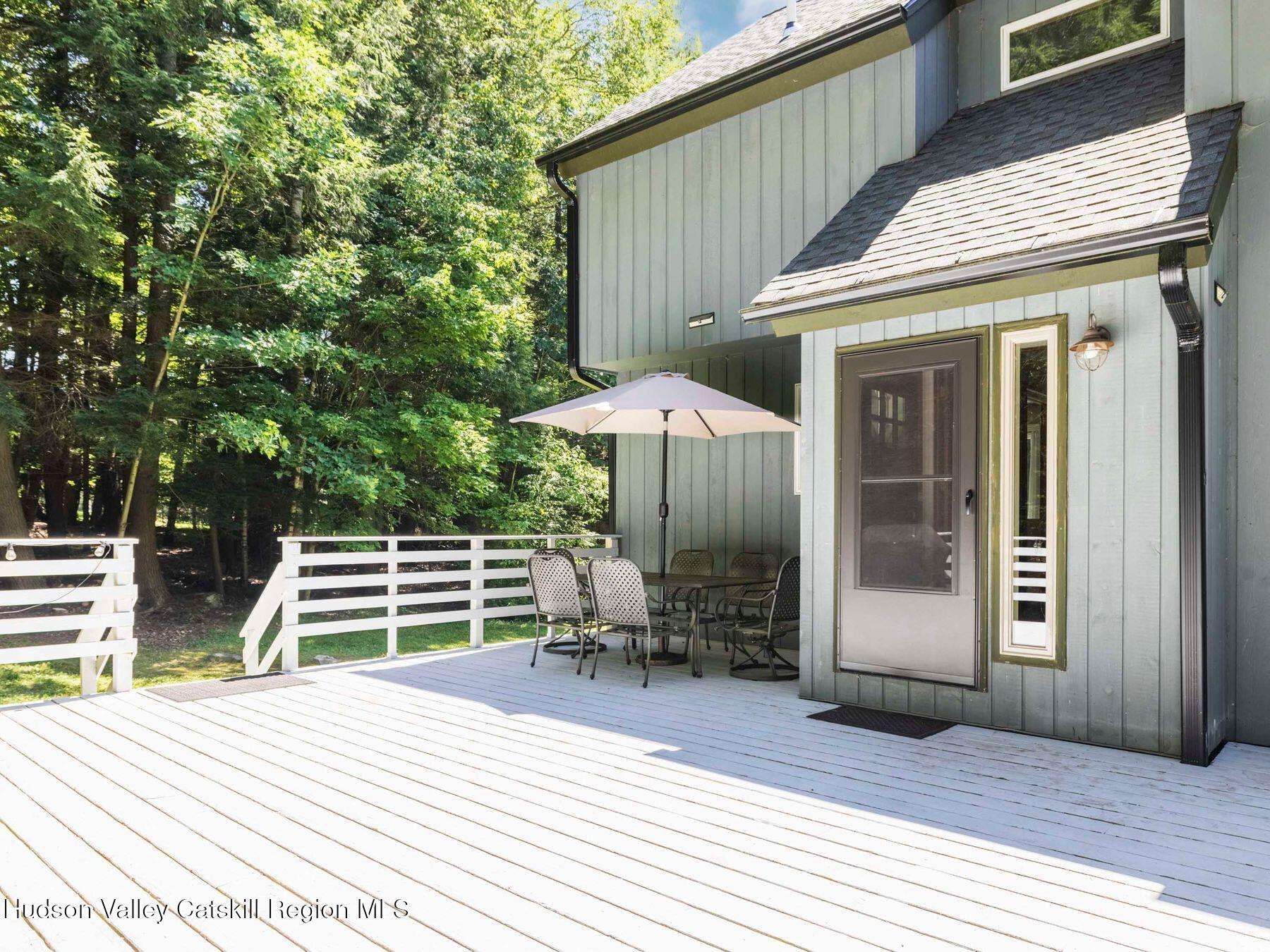 36 Mt Greenery Road Windham, NY 12496 - Photo 40 of 60 a patio with table and chairs and potted plants