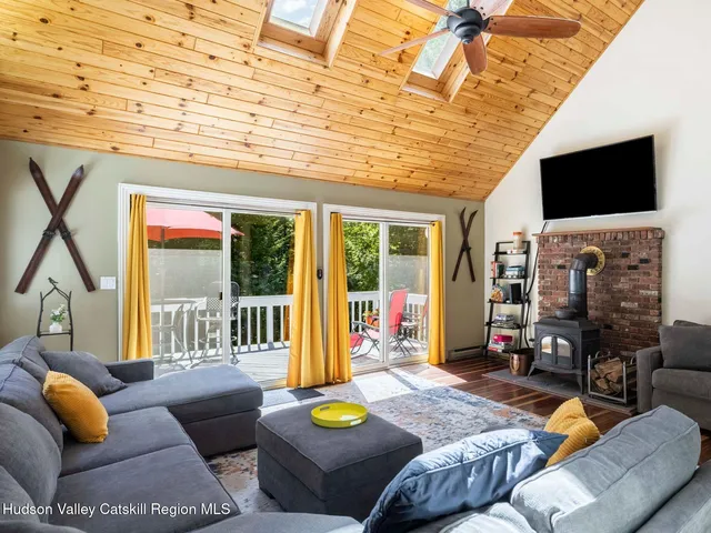 a living room with furniture and a floor to ceiling window