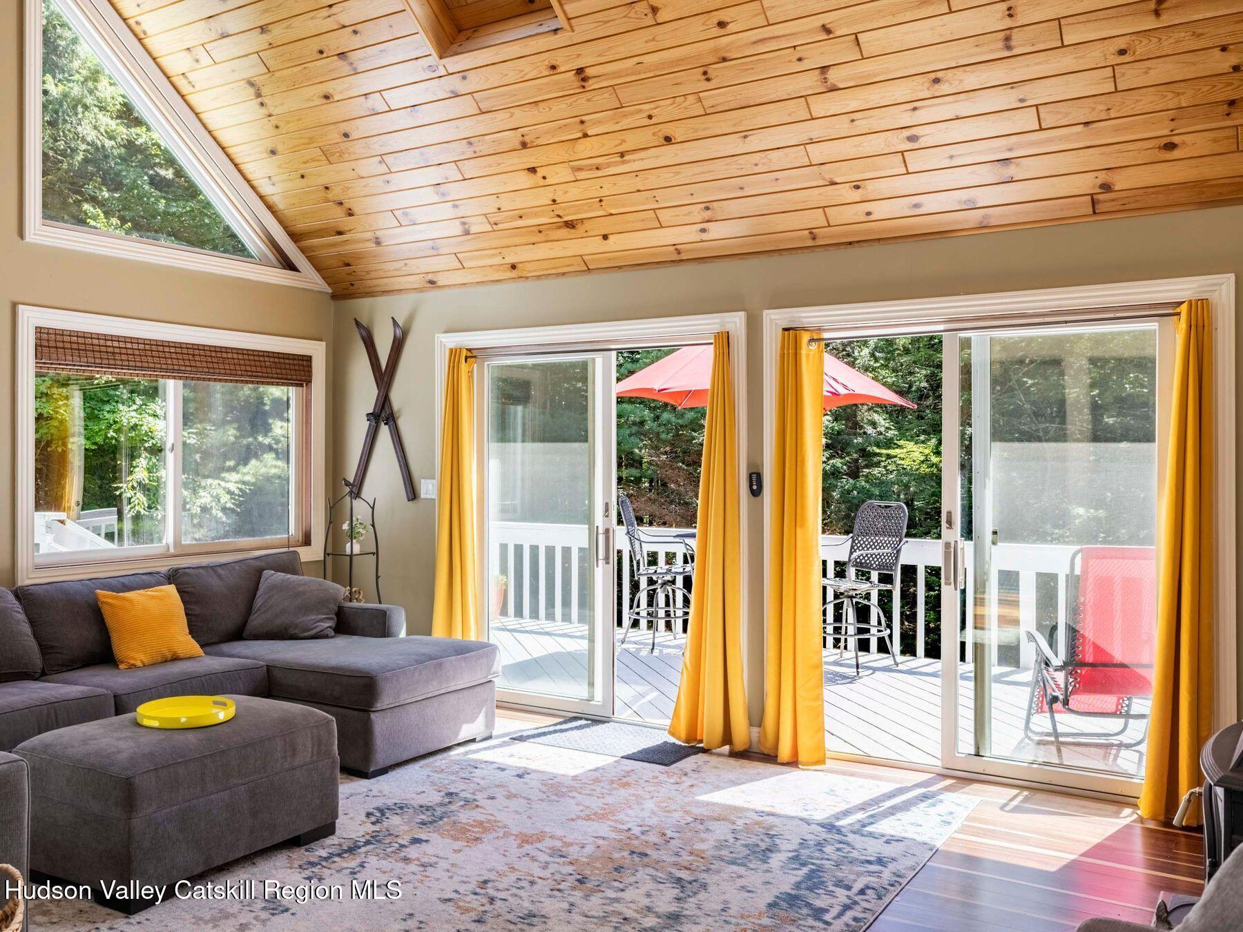 36 Mt Greenery Road Windham, NY 12496 - Photo 9 of 60 a living room with furniture and a floor to ceiling window