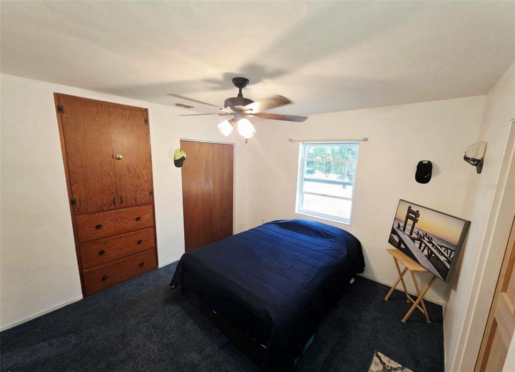 6309 Central Avenue New Port Richey, FL 34653 - Photo 11 of 18 a bedroom with a bed and a dresser