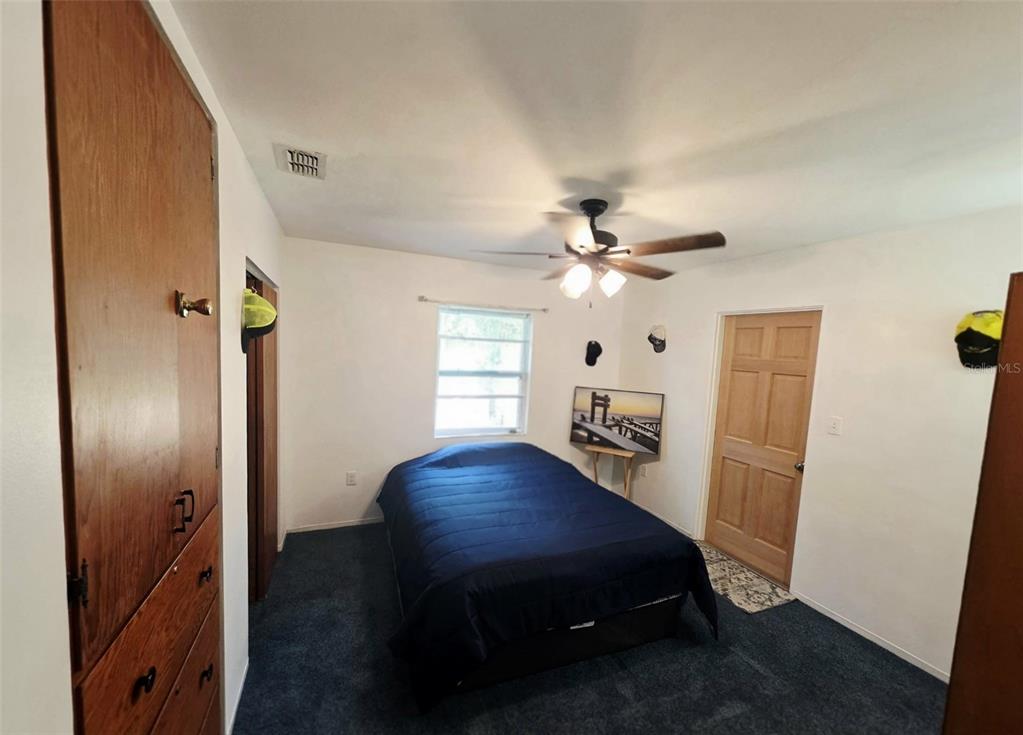 6309 Central Avenue New Port Richey, FL 34653 - Photo 12 of 18 a bedroom with a bed and wooden floor