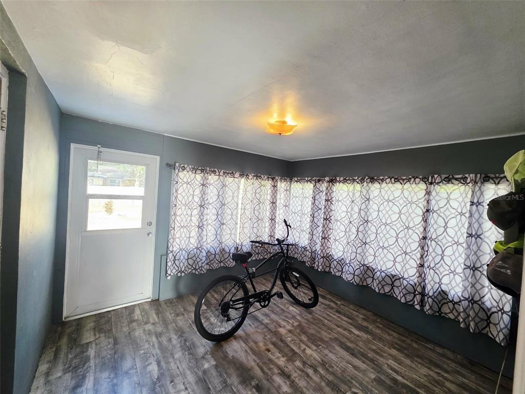 6309 Central Avenue New Port Richey, FL 34653 - Photo 14 of 18 a view of a room with a large window and wooden floor