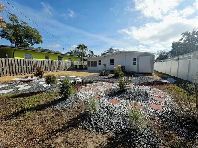 a view of a backyard with sitting area