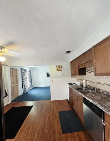 a kitchen with a sink and a stove top oven