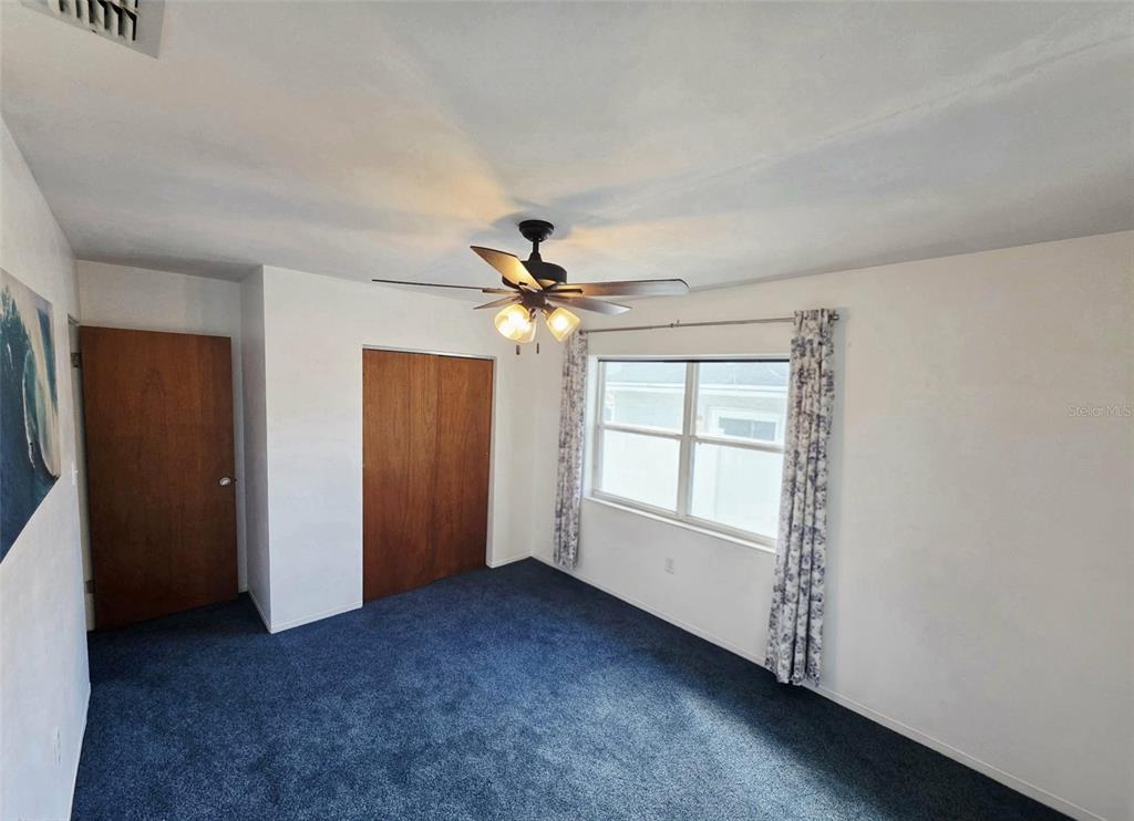 6309 Central Avenue New Port Richey, FL 34653 - Photo 8 of 18 an empty room with windows and fan