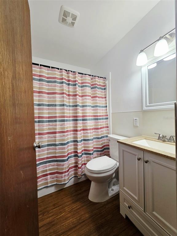 6309 Central Avenue New Port Richey, FL 34653 - Photo 10 of 18 a bathroom with a sink toilet a mirror and shower curtain