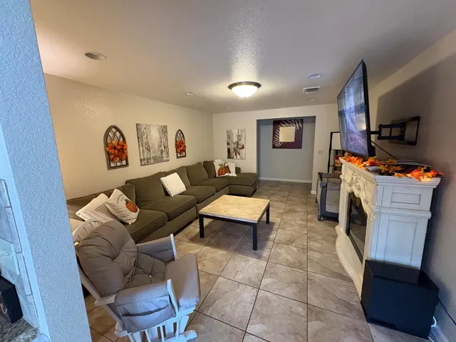 a bedroom with a bed couch and a window