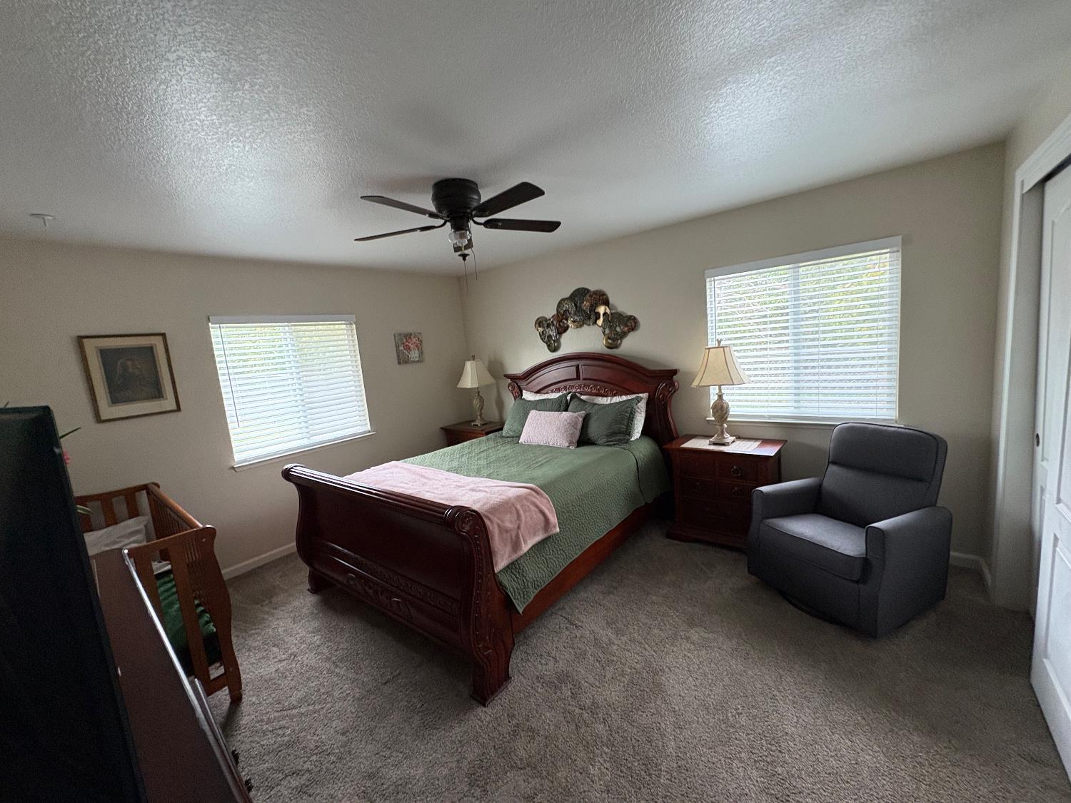 5331 Geer Road Hughson, CA 95326 - Photo 9 of 12 a bedroom with a bed couch and a window