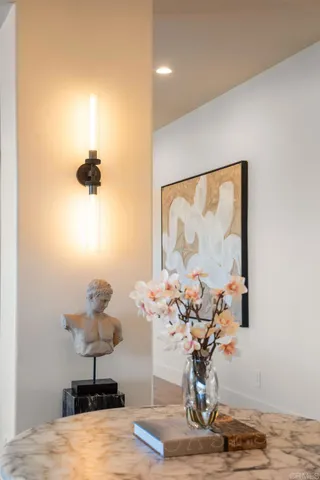 a living room with furniture a fireplace and a large mirror