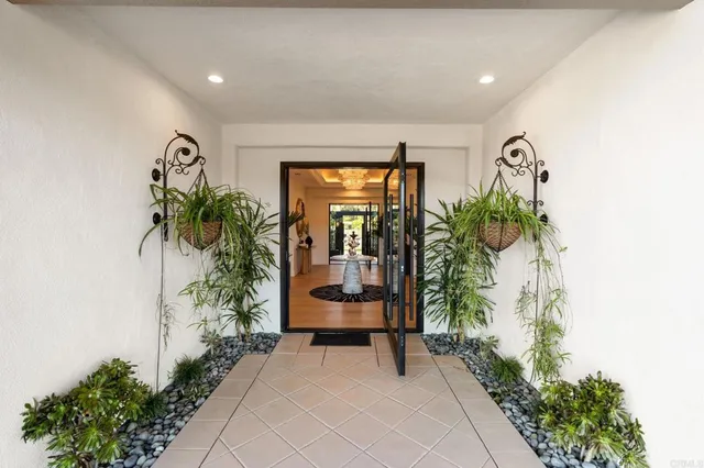 a living room with furniture a fireplace and a chandelier
