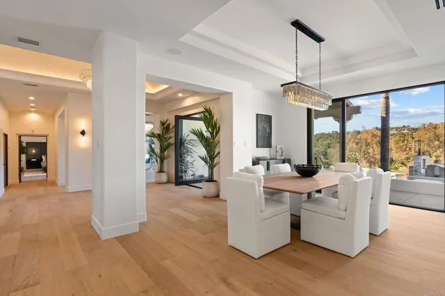 a kitchen with granite countertop a counter space furniture stainless steel appliances and a chandelier