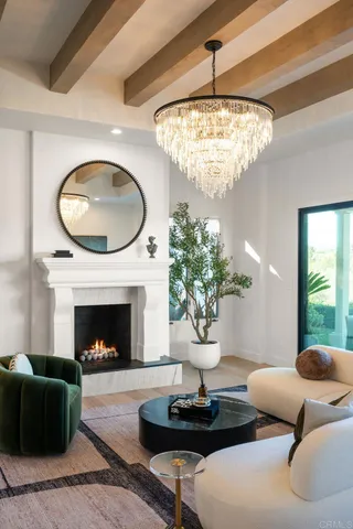 a living room with furniture a large window and a dining table