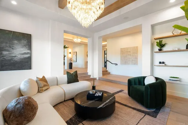 a kitchen with granite countertop a counter space furniture stainless steel appliances and a chandelier