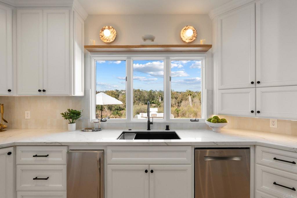 528 Flores De Oro Rancho Santa Fe, CA 92067 - Photo 24 of 75 a kitchen with sink a window and cabinets