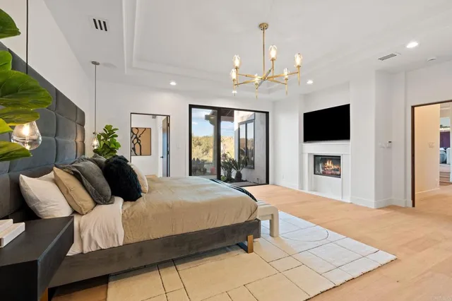 a bathroom with a granite countertop sink a large mirror and a bathtub