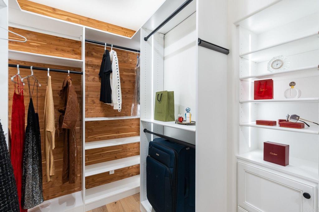 528 Flores De Oro Rancho Santa Fe, CA 92067 - Photo 47 of 75 a view of walk in closet with clothes and shoes