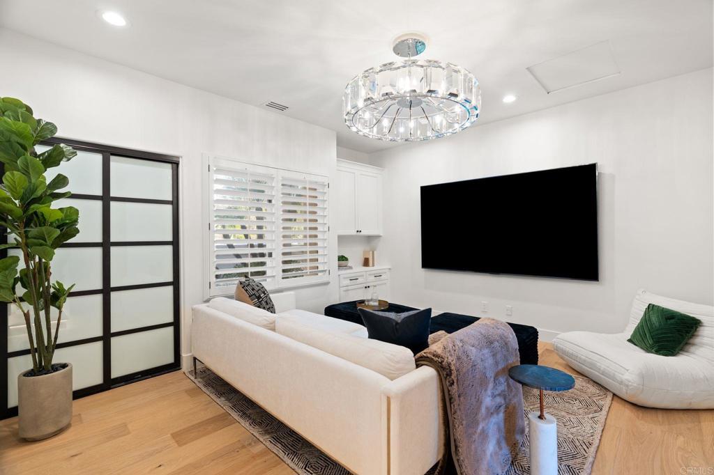 528 Flores De Oro Rancho Santa Fe, CA 92067 - Photo 50 of 75 a living room with furniture a flat screen tv and a chandelier