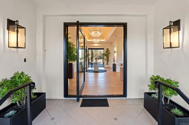 a living room with furniture and a chandelier