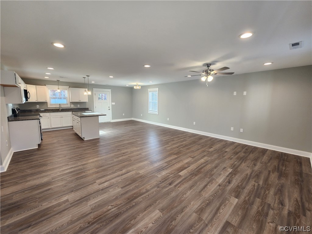 310 Jarratt Jarratt, VA 23867 - Photo 3 of 17 a view of a kitchen with kitchen island a sink wooden floor and stainless steel appliances