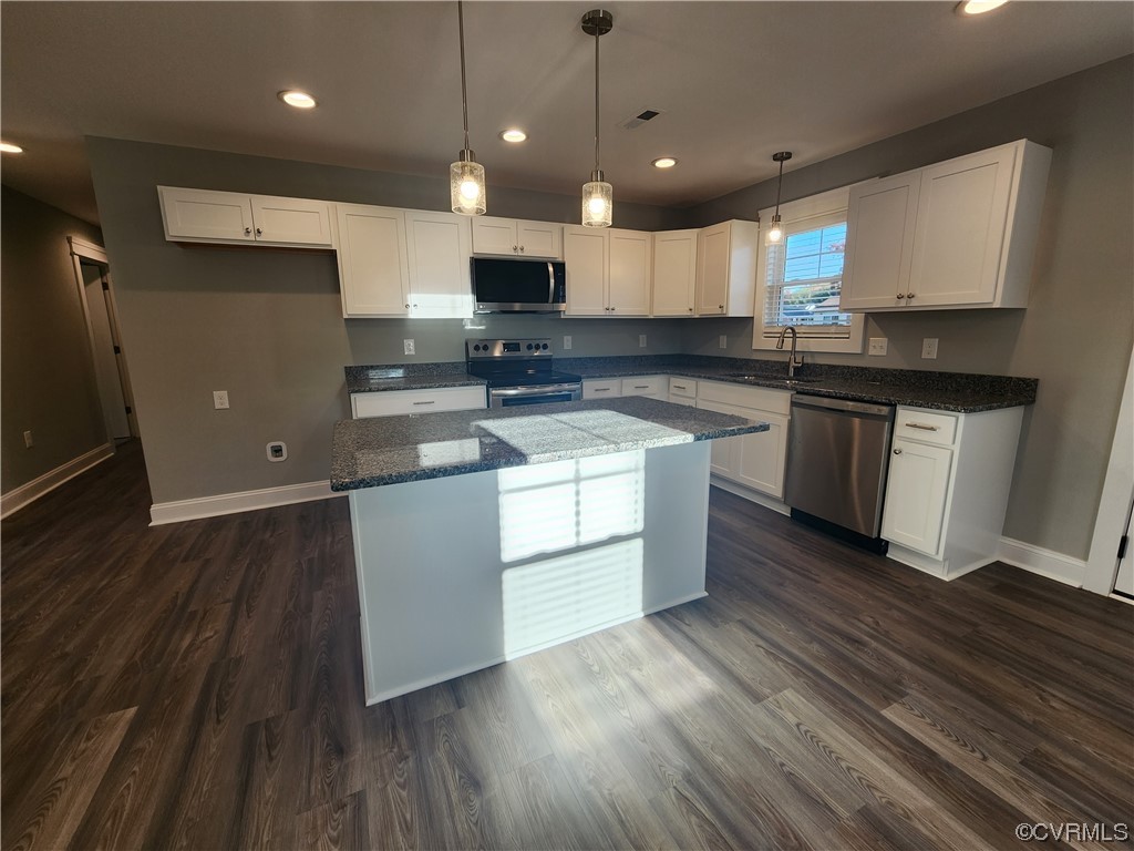 310 Jarratt Jarratt, VA 23867 - Photo 5 of 17 a kitchen with stainless steel appliances granite countertop a sink a stove and a wooden floors