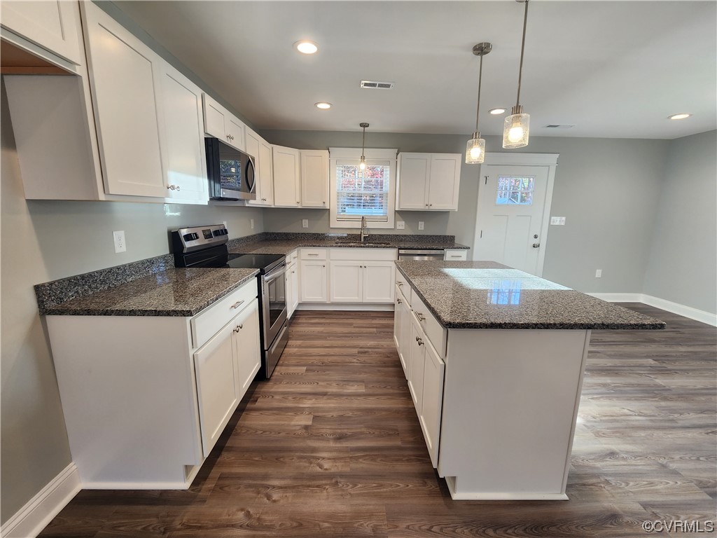 310 Jarratt Jarratt, VA 23867 - Photo 6 of 17 a large kitchen with stainless steel appliances granite countertop a sink a stove top oven a counter space and cabinets