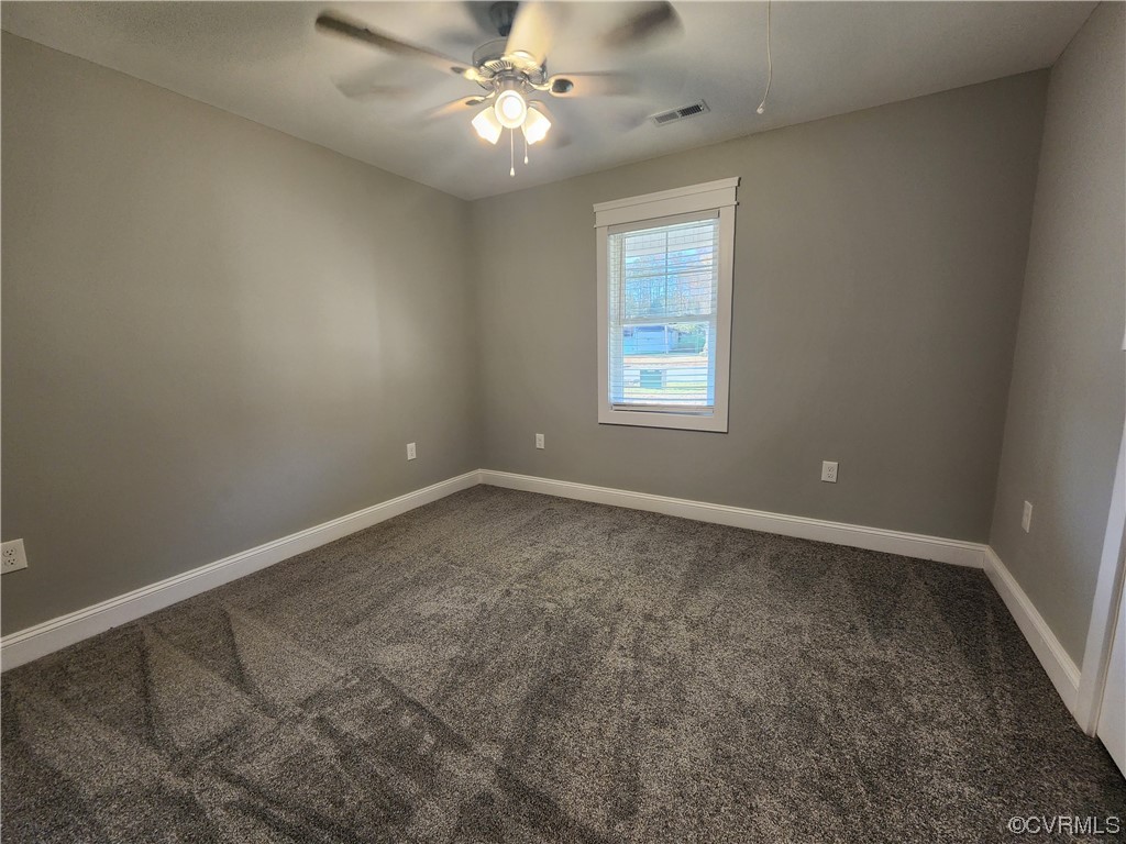 310 Jarratt Jarratt, VA 23867 - Photo 10 of 17 an empty room with a window and a fan