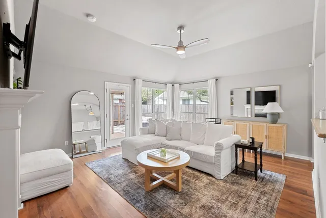 a living room with furniture a flat screen tv and a fireplace