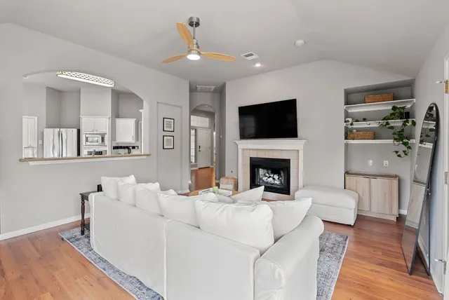 a living room with furniture and a wooden floor