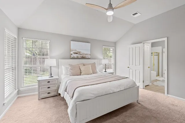 a bathroom with a bathtub and next to a window