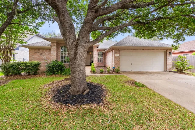 a front view of house with yard and green space