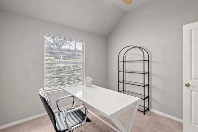 a view of a dining room with furniture and a window