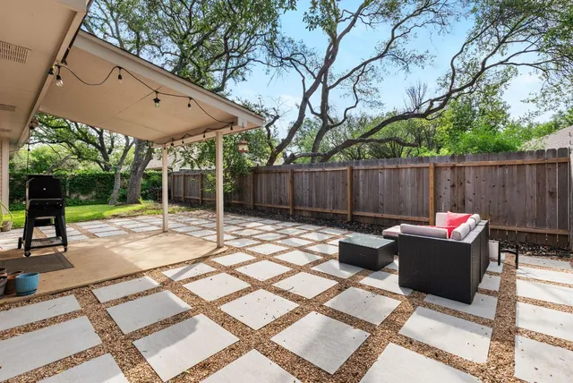 a house view with a sitting space fire pit and outdoor space
