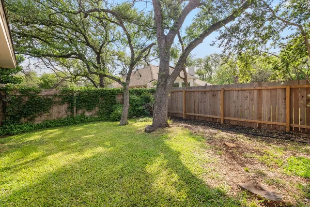 a view of a backyard with a garden and trees