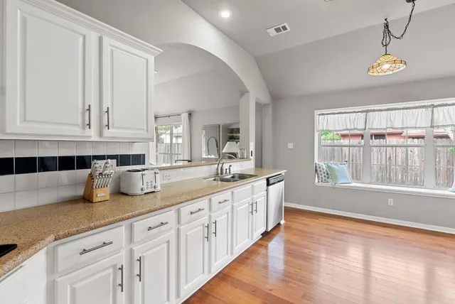 a kitchen with stainless steel appliances granite countertop a refrigerator and a stove