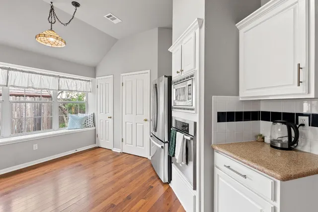 a kitchen with granite countertop a refrigerator and a sink