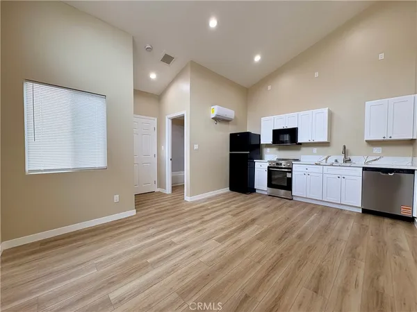 a view of kitchen with cabinets and wooden floor