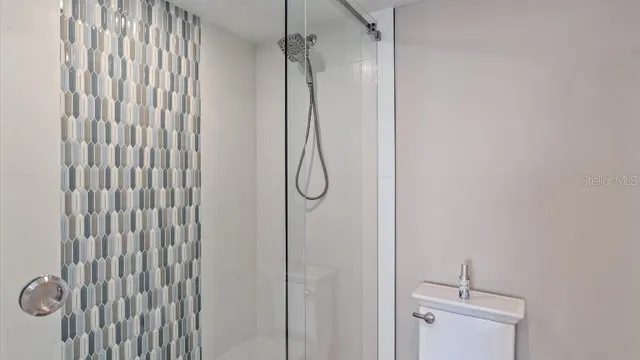 a view of walk in closet and bedroom