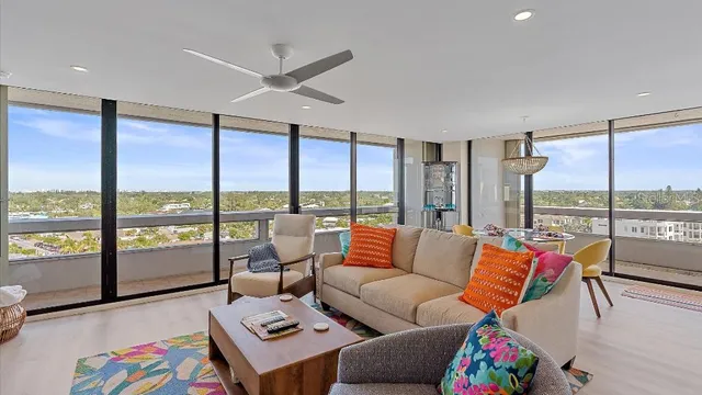 a living room with furniture and a floor to ceiling window