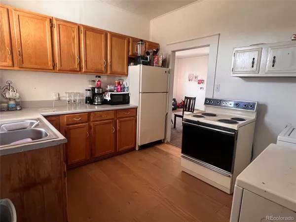 a kitchen with a sink stove and refrigerator