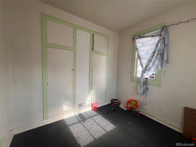 a view of a livingroom with furniture and a flat screen tv