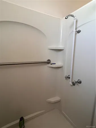 a bathroom with a shower and a toilet