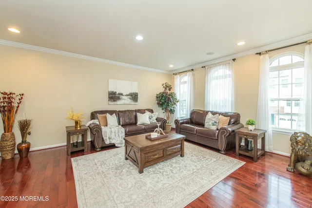 a living room with furniture window and wooden floor