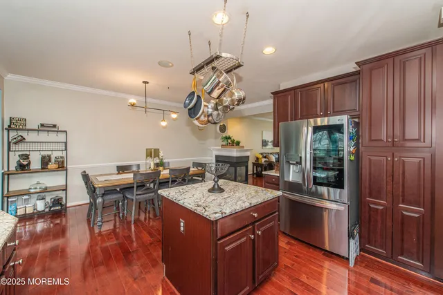 a kitchen with a island in the center and stainless steel appliances