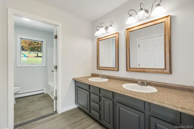 a white bath tub sitting next to a white wall