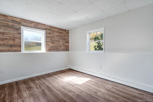 a view of a room with wooden floor and window