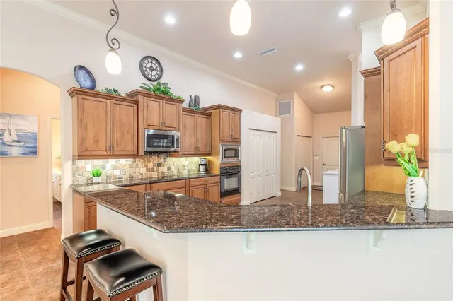 a kitchen with stainless steel appliances granite countertop a stove and a sink